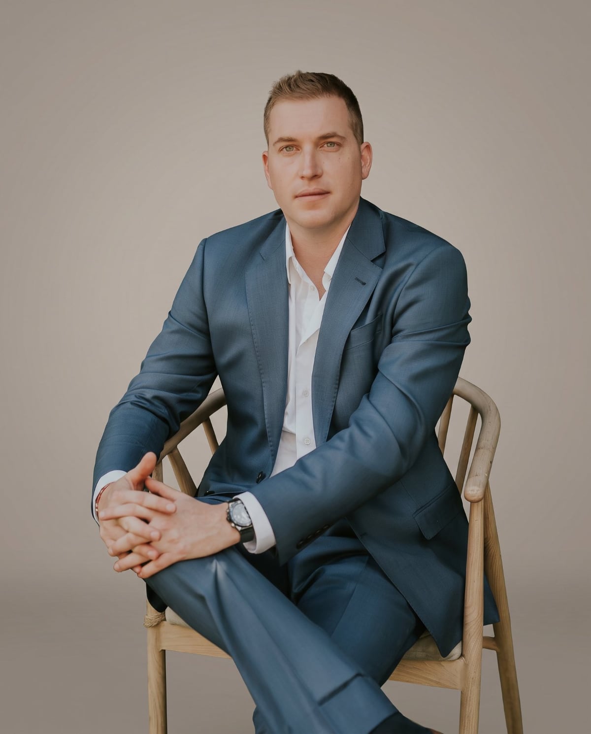 Alik Konovalenko, Los Angeles home builder, seated in a studio portrait